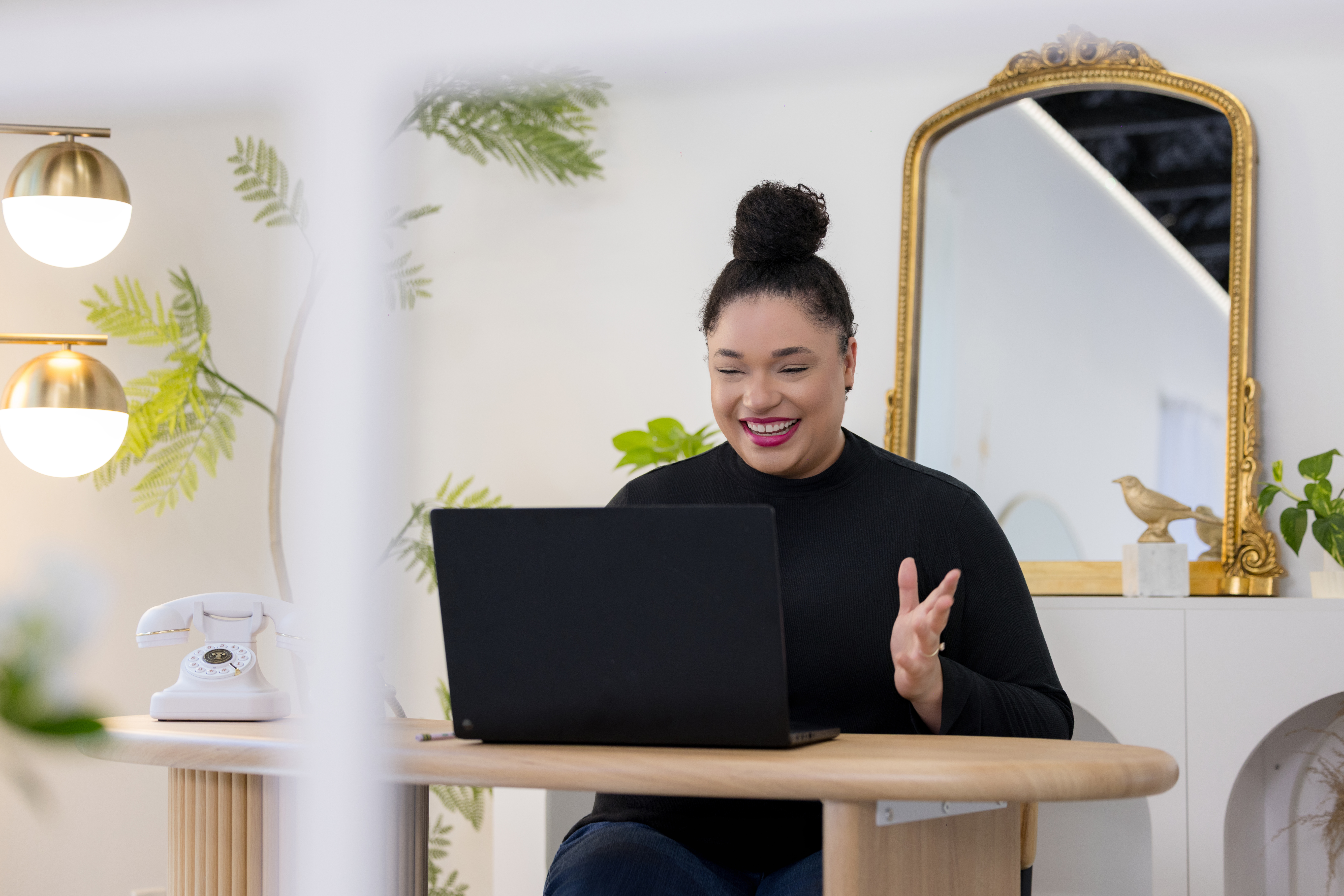 Jillian Thomas on a video call, laughing at her laptop